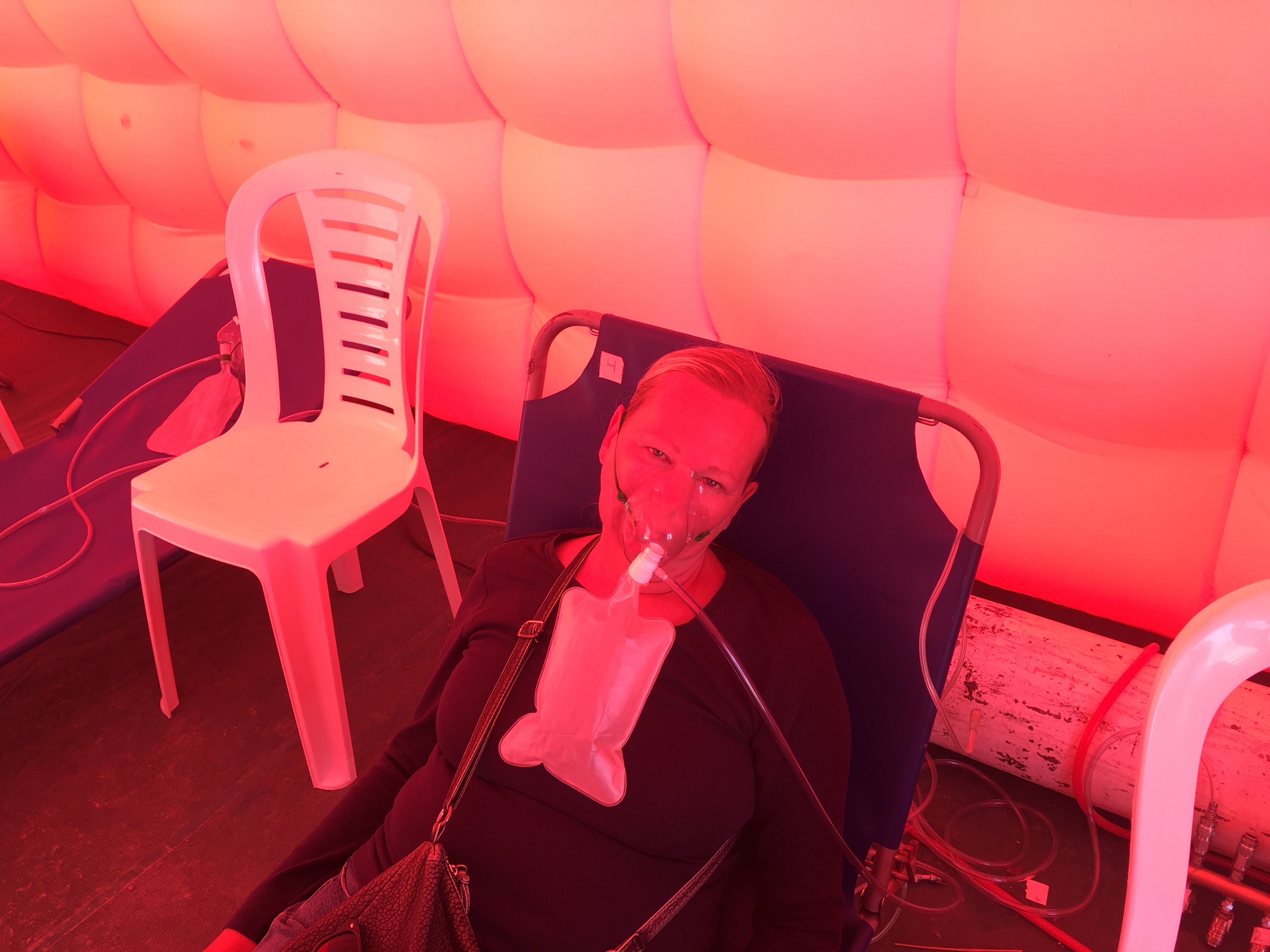 Cate resting with an oxygen mask on her face at Paso Jama, Argentina after suffering side effects from altitude sickness.